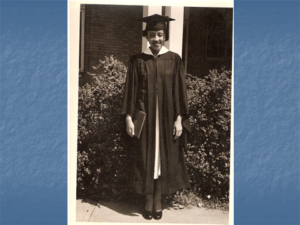 A black and white vintage picture of a woman wearing graduating caps