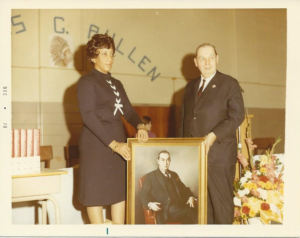 A vintage old picture of a woman holding a paint