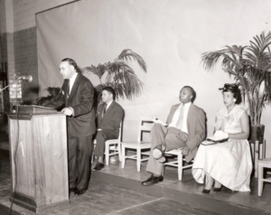 A vintage black and white picture of a man giving a speech