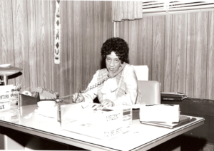 A black and white picture of a woman attending a phone call